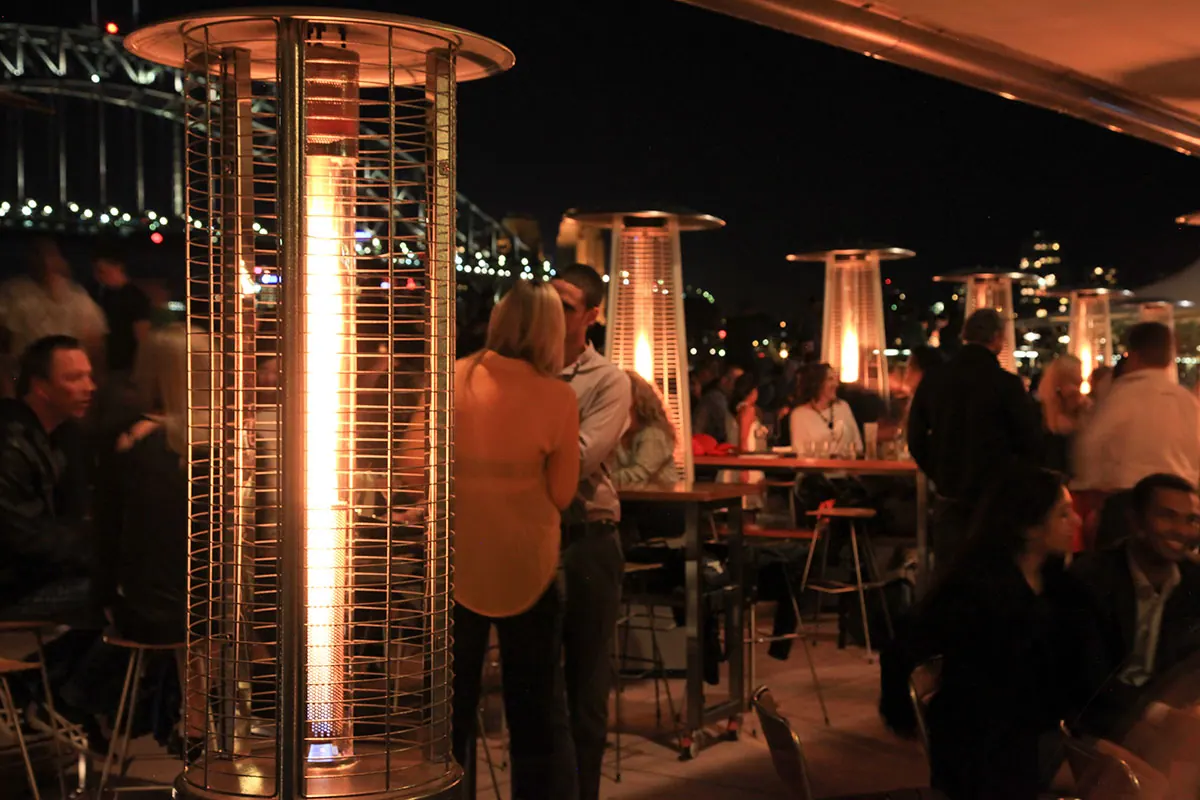 Fire Fountain heaters among diners at night