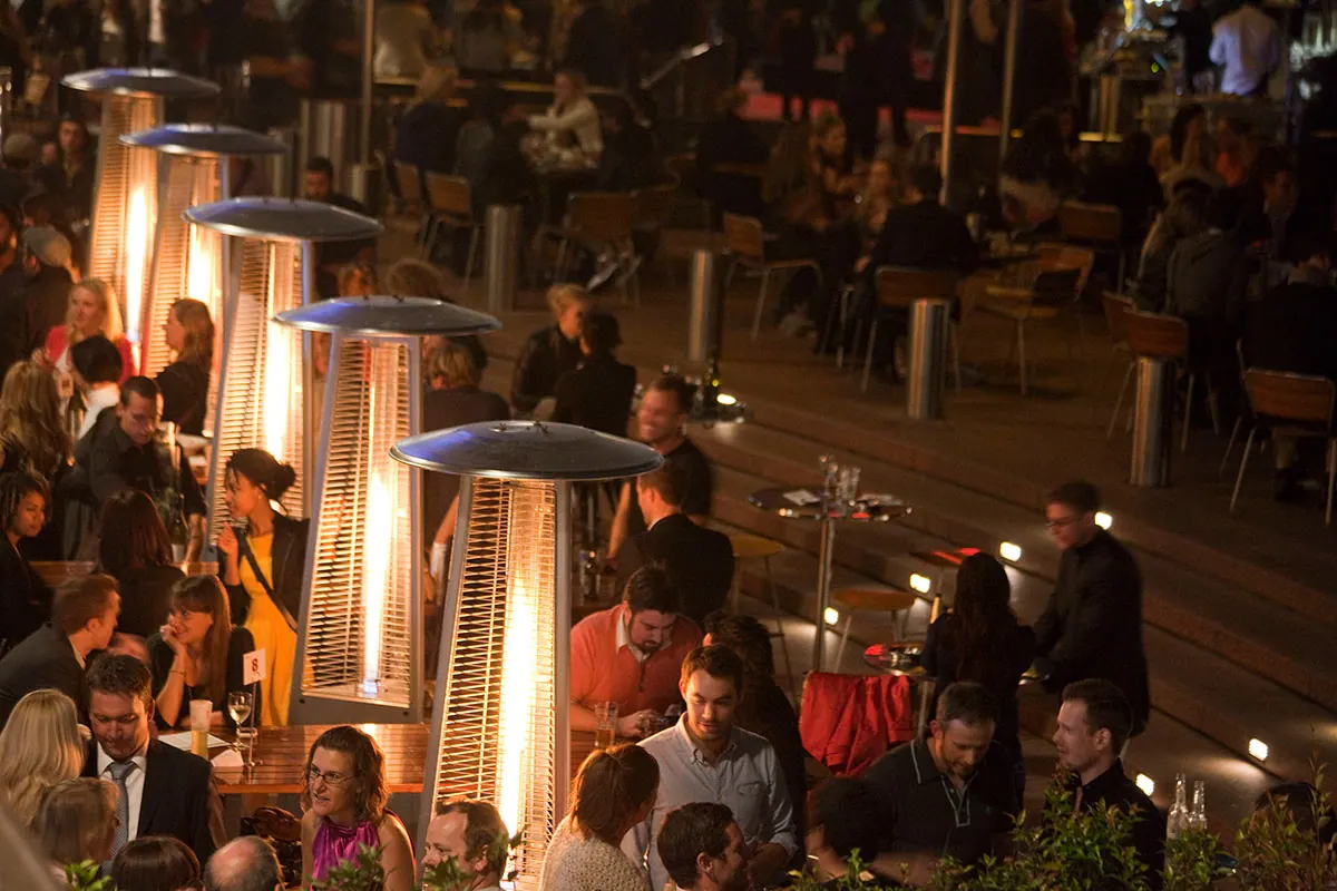 Firestick patio heater in use in a Sydney venue at night